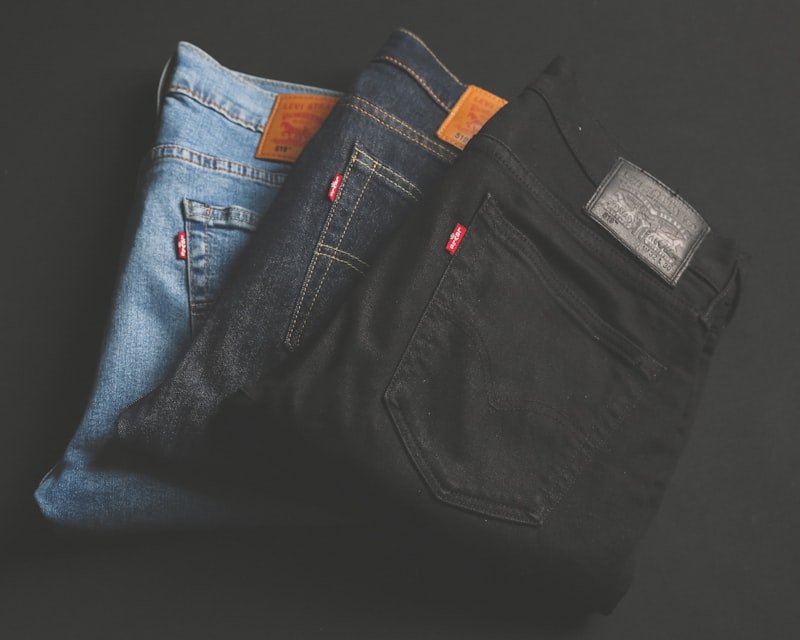Stack of five pairs of jeans hemmed to custom lengths with original stitch preserved